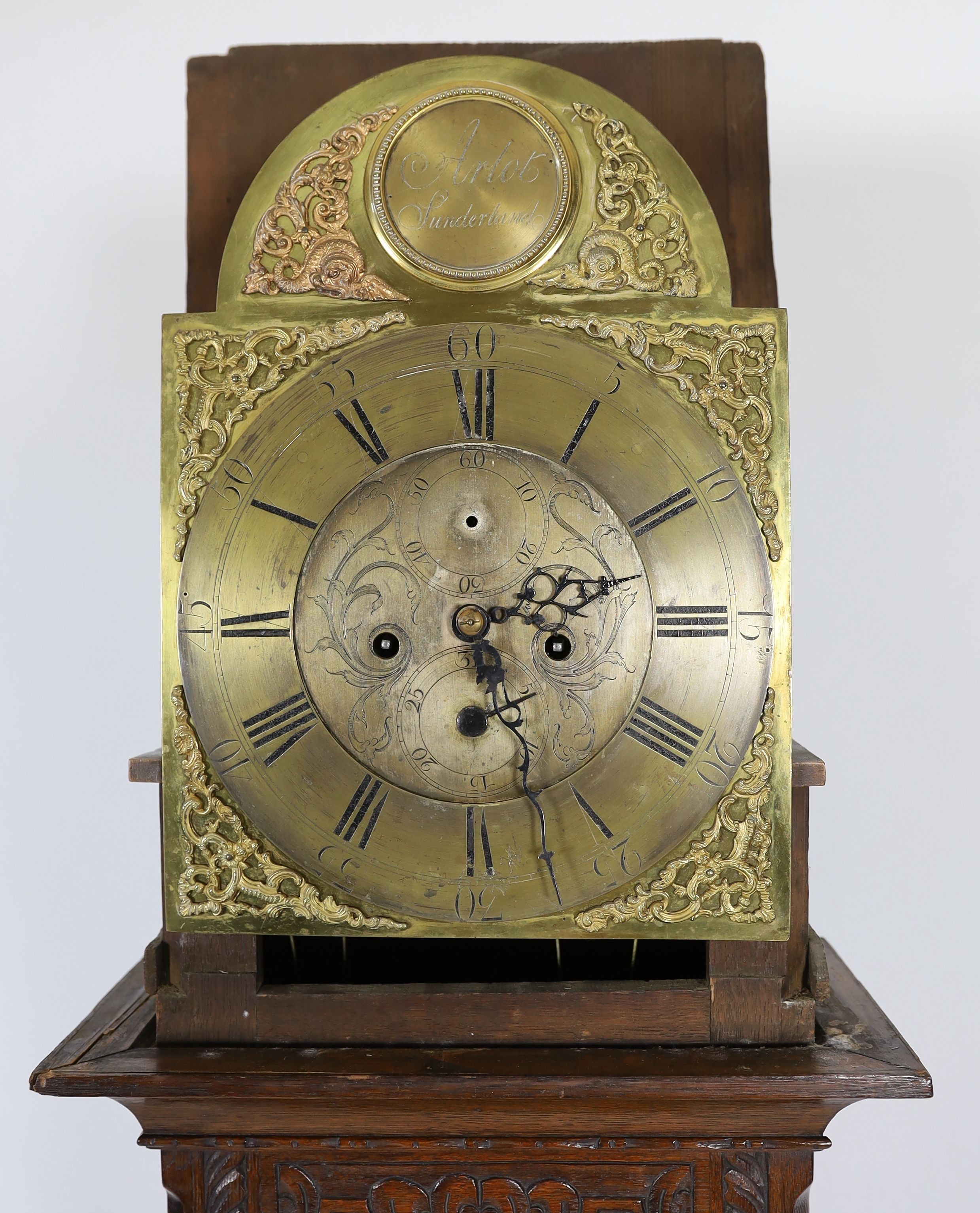 A George III oak eight day longcase clock, the 30cm arched dial marked Arlot, Sunderland, with subsidiary seconds and calendar dials, case 250cm high (later carved)